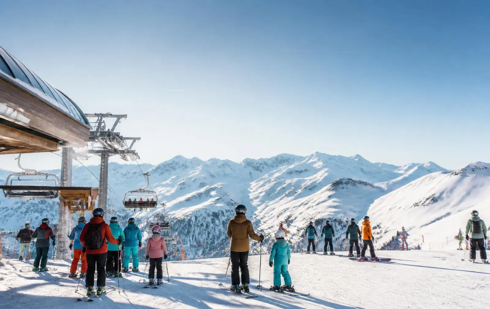 Skiers and families at the foot of a ski lift
